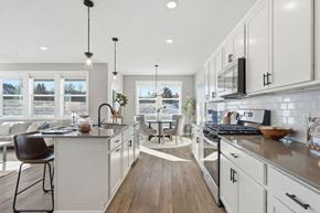 Lakeville apartment for rent - A modern kitchen with white cabinets and a wooden floor.