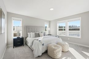 Lakeville apartment for rent - A bedroom with a large bed and a window overlooking a snowy landscape.