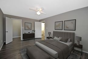 Royal Oak apartment for rent - A bedroom with a large bed and a ceiling fan.