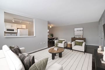 Royal Oak apartment for rent - A modern living room with a white sofa set and a coffee table.