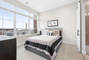 Cleveland apartment for rent - A bedroom with a large bed and a view of the city.