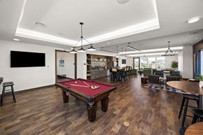 Ankeny apartment for rent - A room with a pool table and a bar area.