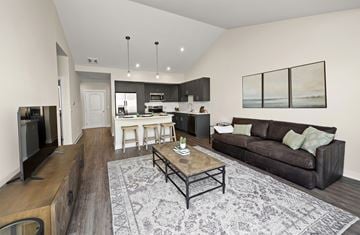 Ankeny apartment for rent - A modern living room with a brown couch and a coffee table.