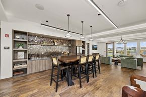 Ankeny apartment for rent - A dining room with a wooden table and chairs.
