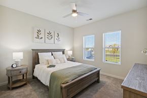 Kenosha apartment for rent - a bedroom with a bed and two windows