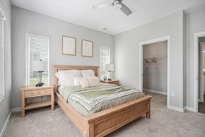 Grand Rapids apartment for rent - A bedroom with a bed, nightstand, and window.