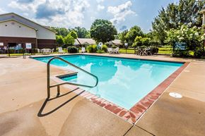 Conway apartment for rent - A large outdoor swimming pool with a red brick border.