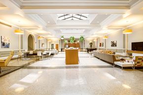 Detroit apartment for rent - A spacious cafeteria with tables and chairs and a counter.
