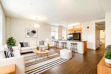 Detroit apartment for rent - A modern living room with a white couch and a coffee table.