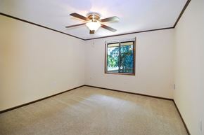 Ann Arbor apartment for rent - A room with a ceiling fan and a window.