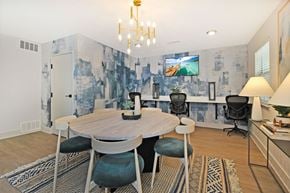 Portage apartment for rent - a dining room with a table and chairs and a tv on the wall