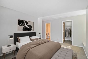 Portage apartment for rent - A bedroom with a large bed and a painting on the wall.