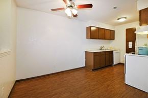 Farmington Hills apartment for rent - A kitchen with brown cabinets and a white counter.