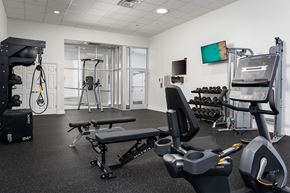 Cincinnati apartment for rent - a gym with exercise equipment and a tv