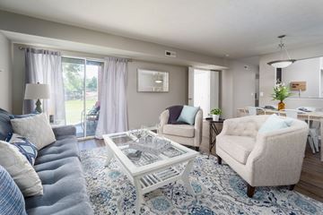 Cincinnati apartment for rent - a living room with couches and chairs and a table