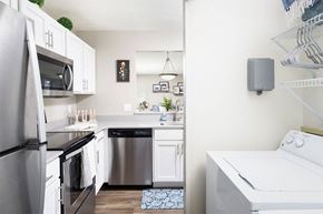 Cincinnati apartment for rent - an empty kitchen with stainless steel appliances and white cabinets