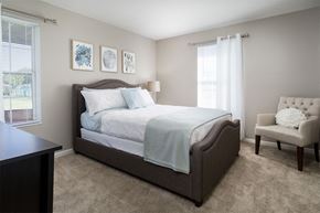 Cincinnati apartment for rent - a bedroom with a bed and a chair