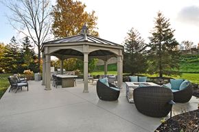 Shelby Township apartment for rent - a patio with a gazebo and tables and chairs