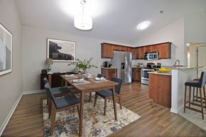 Shelby Township apartment for rent - an open kitchen and dining room with a wooden table and chairs