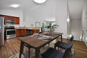 Shelby Township apartment for rent - an open kitchen and dining room with a wooden table and chairs