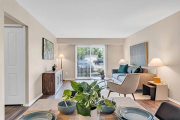 Farmington Hills apartment for rent - A living room with a couch, chair, and table with a plant on it.