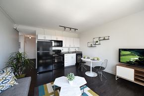 Detroit apartment for rent - A modern kitchen with black appliances and white cabinets.