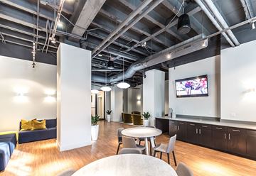 Detroit apartment for rent - A modern living room with a television and a dining table.