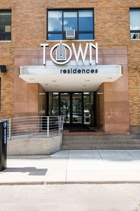 Detroit apartment for rent - The front of a building with the words "Town Residences" on it.