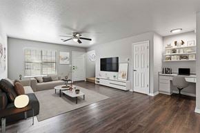 Bentonville apartment for rent - A living room with a couch, a coffee table, a television, and a desk.