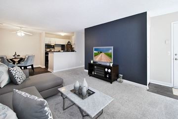 Troy apartment for rent - A living room with a grey sofa and a grey coffee table.