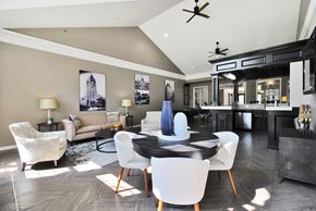 Troy apartment for rent - A modern dining room with a black table and white chairs.