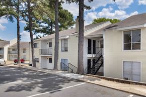 Little Rock apartment for rent - A row of apartment buildings with trees in front.