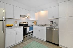 Saginaw apartment for rent - a white kitchen with stainless steel appliances and white cabinets