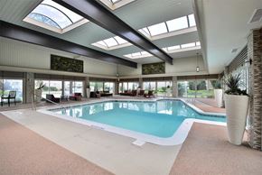 Saginaw apartment for rent - a swimming pool in the middle of a building with windows