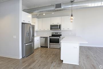 St. Paul apartment for rent - A modern kitchen with a white refrigerator, stove, and oven.