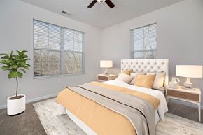 Grove City apartment for rent - a bedroom with a bed and a ceiling fan