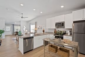 Ofallon apartment for rent - a kitchen with white cabinets and stainless steel appliances