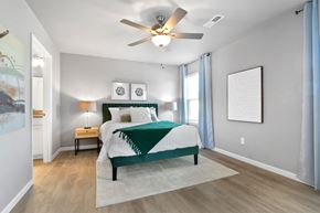 Ofallon apartment for rent - a bedroom with a bed and a ceiling fan