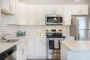 Grand Rapids apartment for rent - A kitchen with white cabinets and a stainless steel refrigerator.