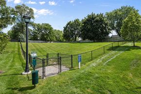 Grand Rapids apartment for rent - A green sign is on a pole in a grassy area.