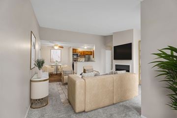 Canton apartment for rent - A living room with a beige couch and a television on the wall.
