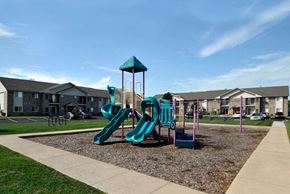 South Rockwood apartment for rent - A playground with a green slide and a blue and green play structure.