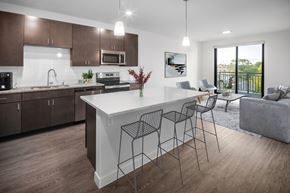 Middleton apartment for rent - A modern kitchen with a white island and dark brown cabinets.