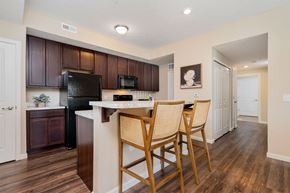 Columbus apartment for rent - a kitchen with a bar with three chairs
