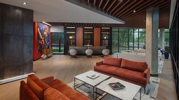 Middleton apartment for rent - a living room with orange couches and a table and chairs