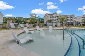 Myrtle Beach apartment for rent - A pool with a slide and sun loungers.