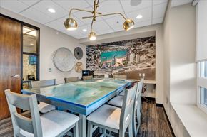 Detroit apartment for rent - A modern dining room with a glass table and grey chairs.