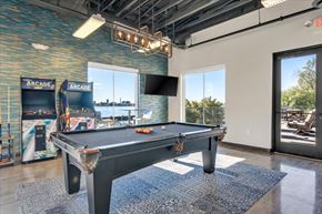 Detroit apartment for rent - A pool table in a room with a view of the outdoors.