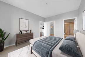Detroit apartment for rent - A bedroom with a large bed and a dresser.