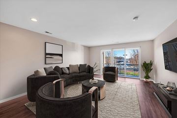 Detroit apartment for rent - A living room with a black couch and a television.